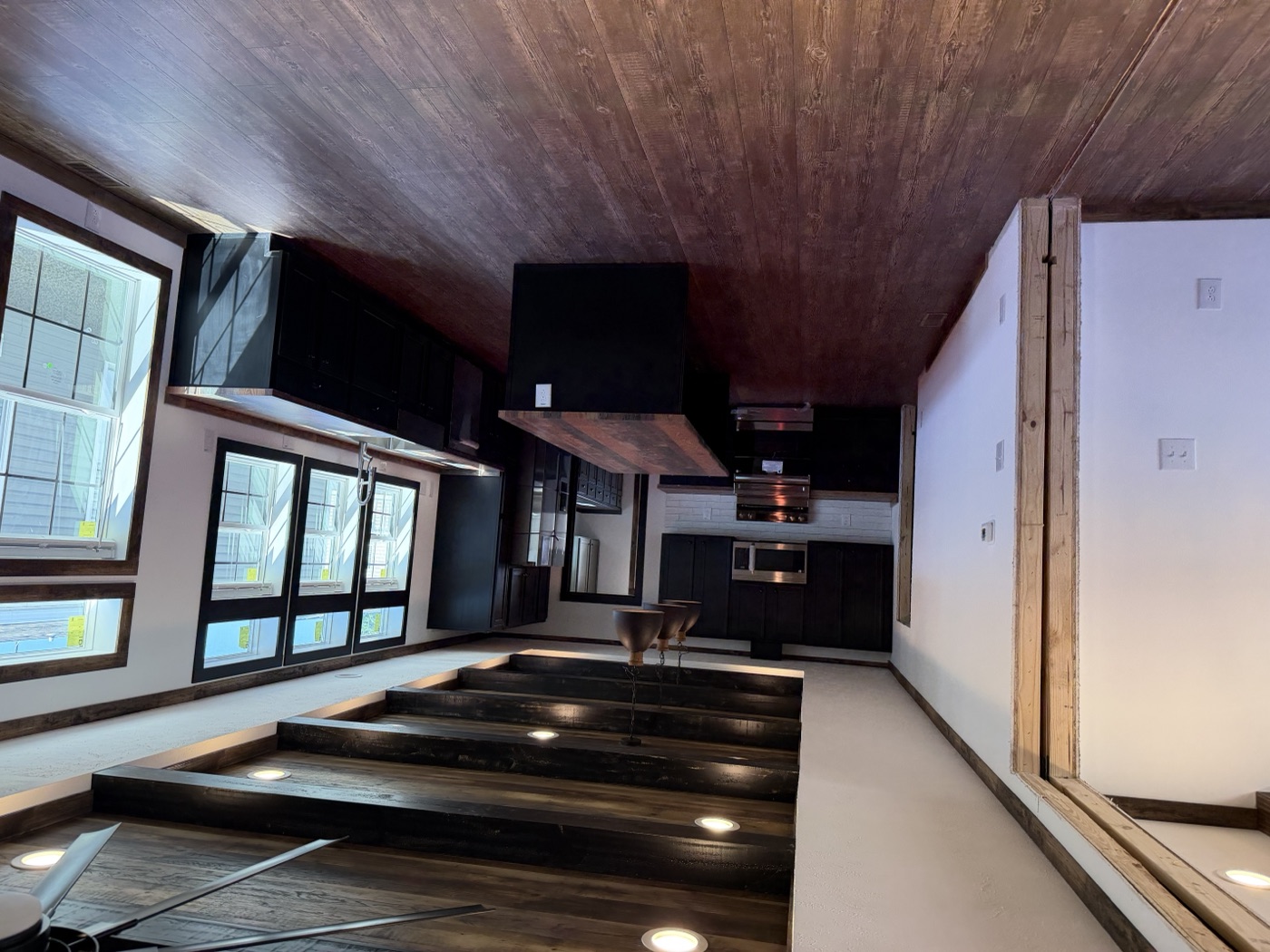 Open living and kitchen with beam ceiling